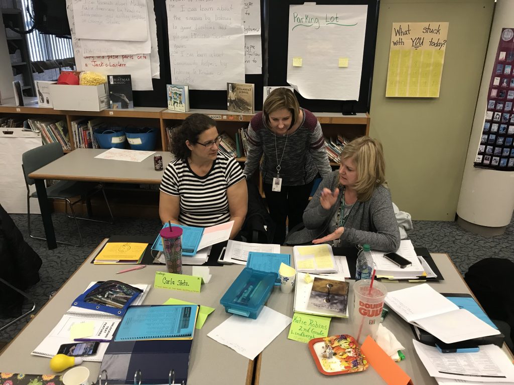 3 teachers collaborating on literacy related research