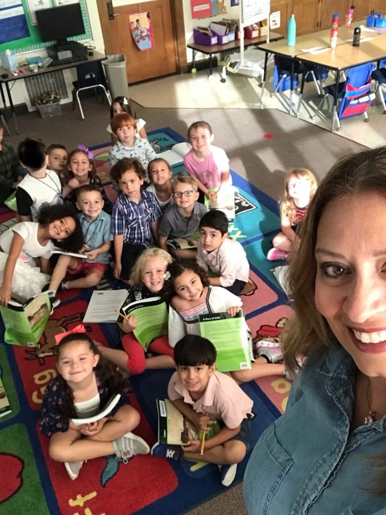 Students gathered on the carpet for a picture with their math books