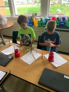 students use materials to build wind turbines