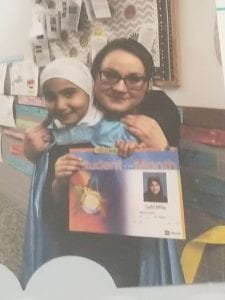 Ms. Rangel is lovingly holding her student of the month, Laila Elhaj.