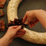 "Punching" fabric squares into the wreath