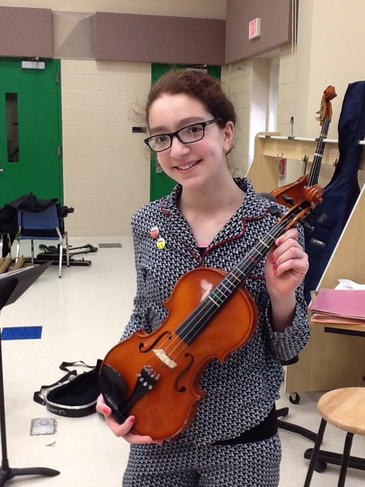 Viola student with cadet and intermediate pins