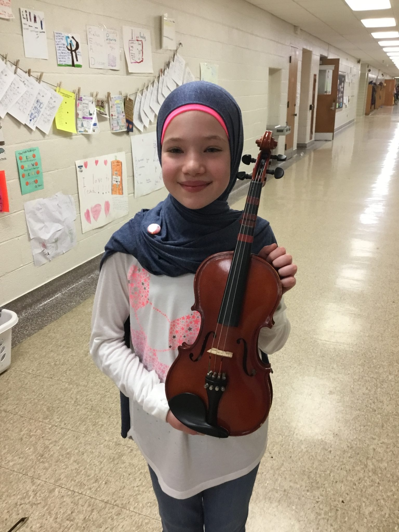 This young violinist is proudly wearing her newly awarded Intermediate Pin.