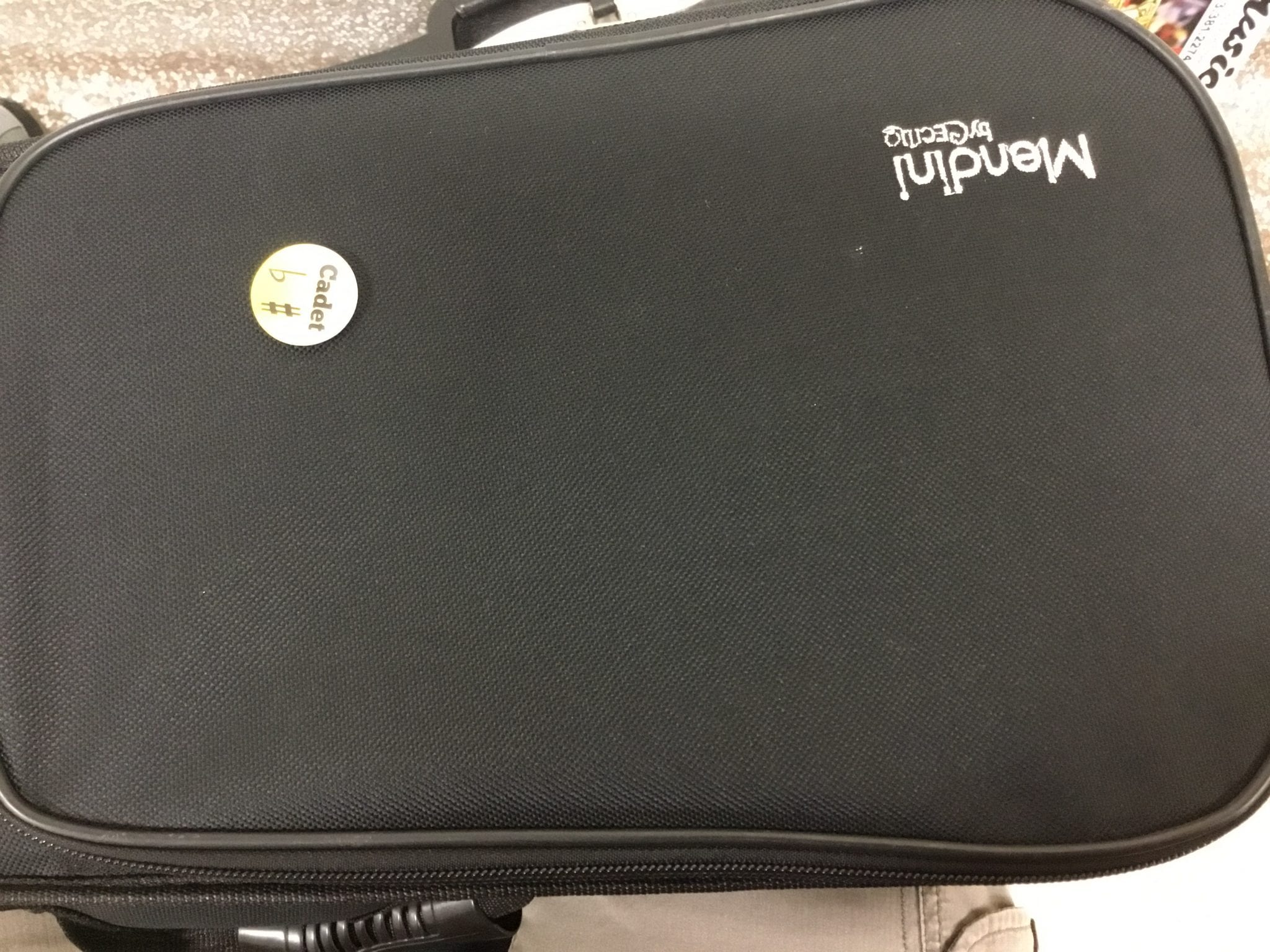 A proud student displays the earned cadet pin on his or her instrument case.