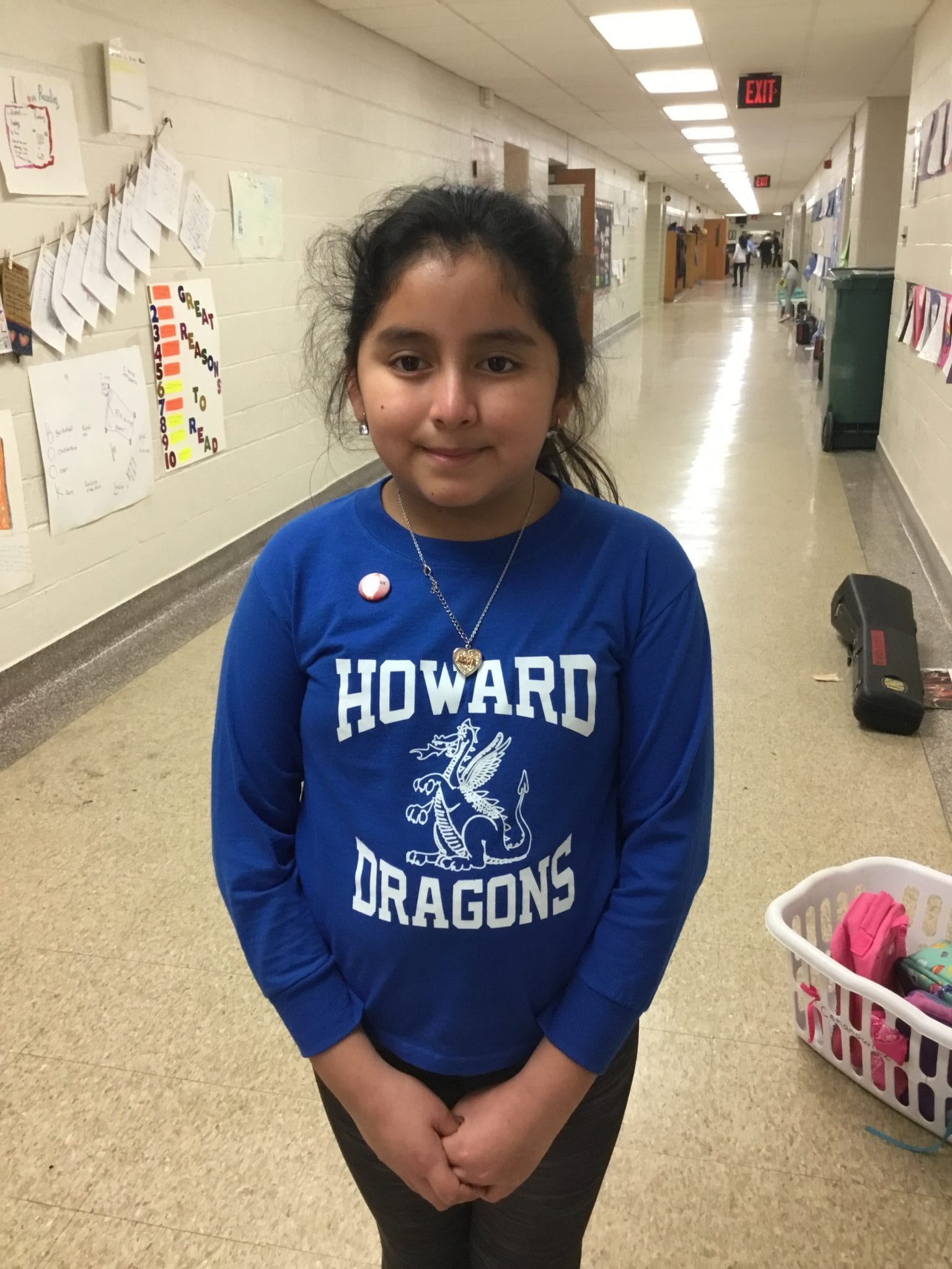 A young flutist is proudly wearing her newly awarded Intermediate Pin.