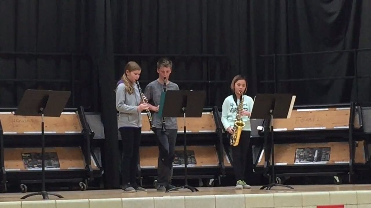 Three very talended band students perform for their school talent show.