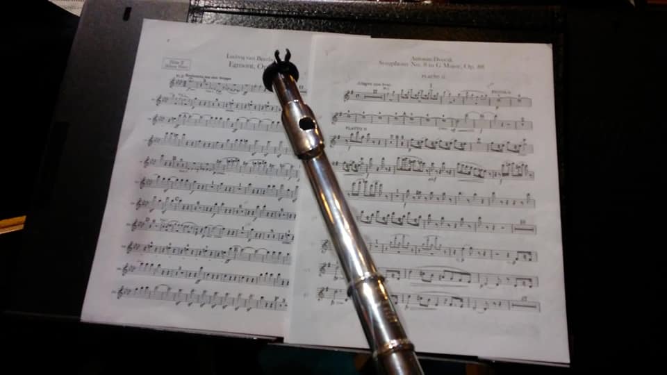Mrs. Reed’s flute is poised across some of her sheet music for the concert.