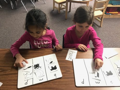 Kindergarten completing a picture sort based on beginning sounds