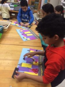 Students are adding the right size shape on top of each building.