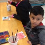 Kindergarteners working on creating their shape books