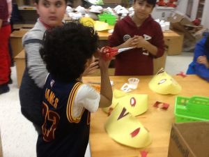 Drawing, cutting and gluing the eyes to the three dimensional paper mask