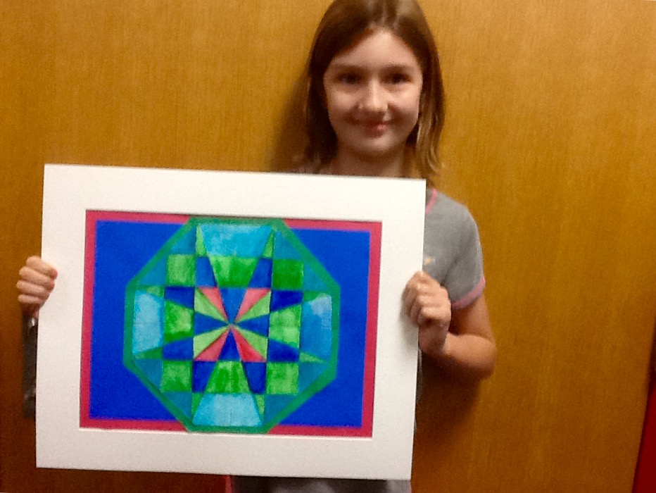 Kelly holding her artwork