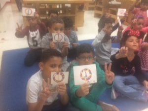 Students using making the V sign and showing their Peace symbol