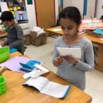 Students writing about the self=portrait in their journal