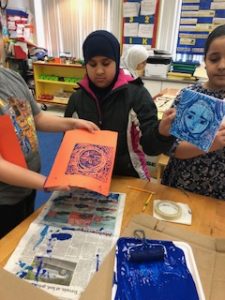 Students creating their prints using the printmaking technique