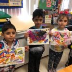 kindergartners are showing their abstract artworks