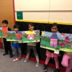 Students holding their artwork that was selected to be displayed at Artspace