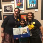 Students at the art show with family and staff.