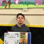 Ali G. with his teachers Showing his certificate and ribbon.