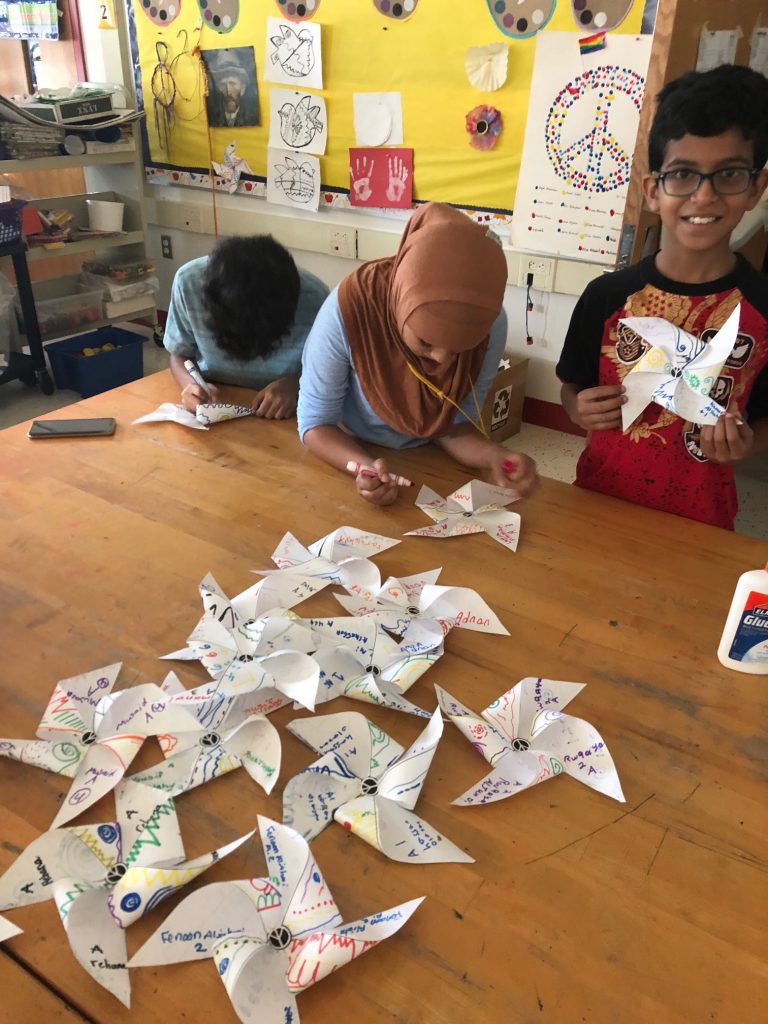 Students are folding the pinwheel after they finished designing.