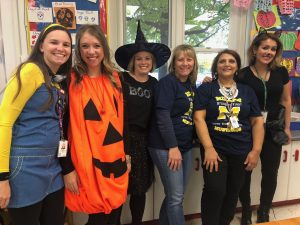 Teachers are  having fun helping students during the Boo Bash event