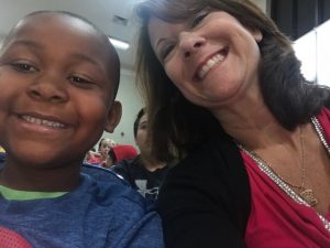 Mrs. Peterson and a kindergarten student enjoying the leadership assembly.