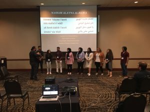 Students in front of screen presenting information.