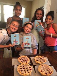 Five girls holding books.