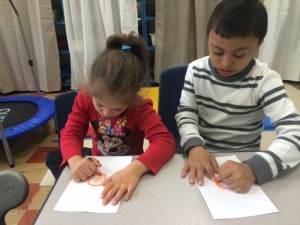 These students are practicing coloring by staying within the circle that they can actually feel - this is a wikki stick and provides tactile feedback and helps with learning how to stay within the lines.