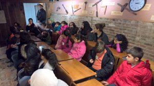 Students sitting at old time school desks. 