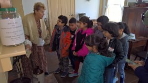 Students learning the history of the Gardner House. 