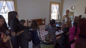 Students learning the history of the Gardner House. 